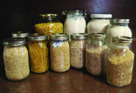 glass jars filled with dried pasta, flour, and beans with oxygen
